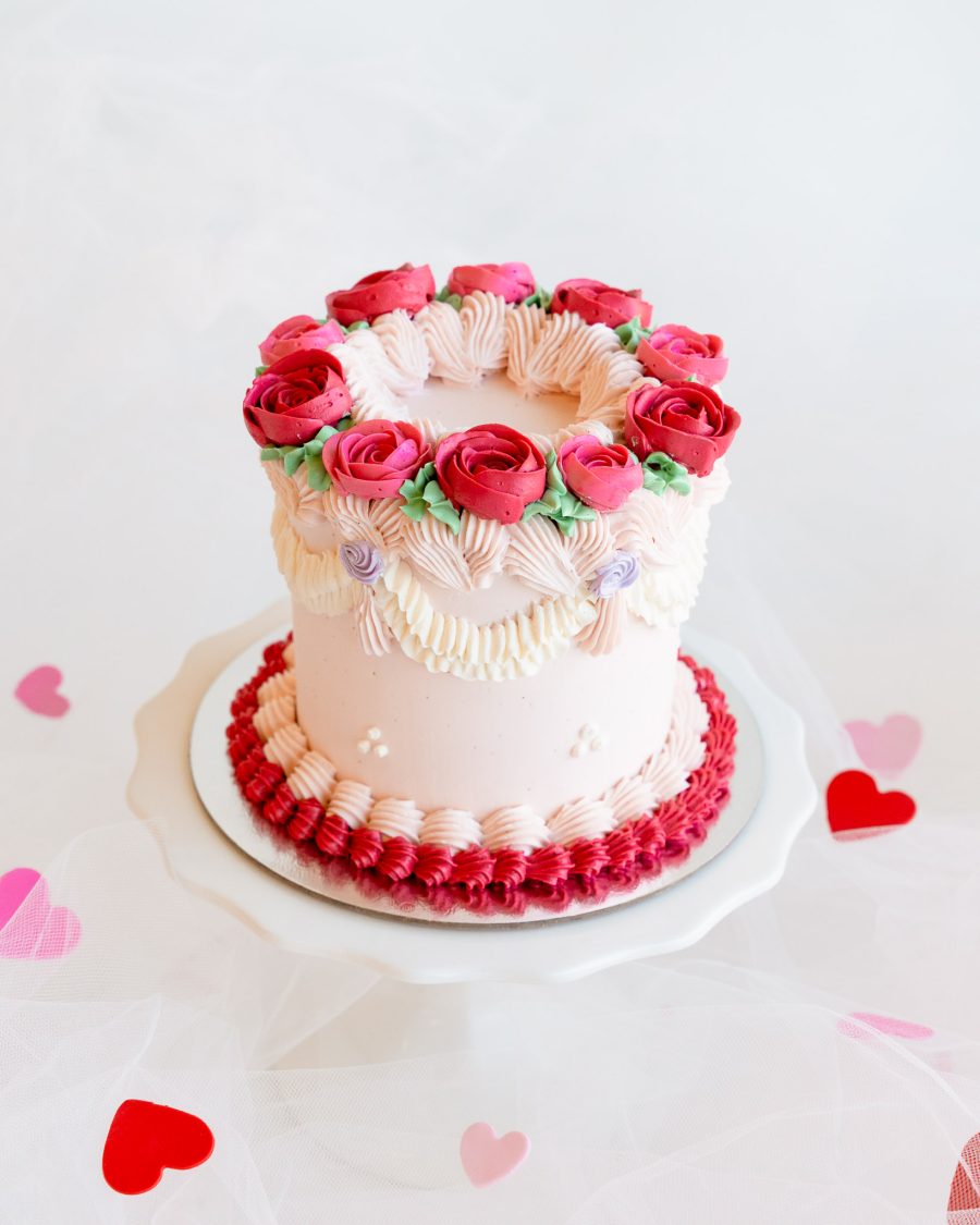 Valentine's Roses Cake A mini Valentine's cake decorated with red and pink buttercream roses and piped details.