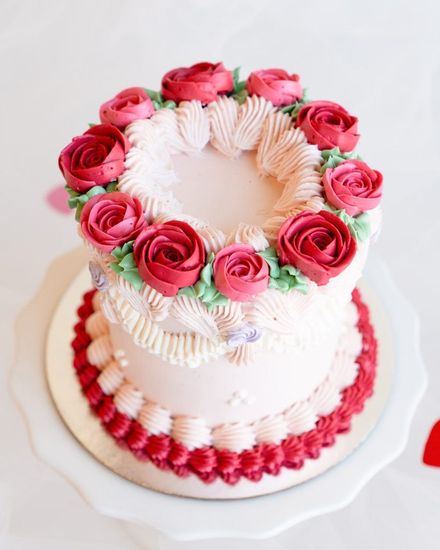 Valentine's Roses Cake close up Close-up view of red and pink buttercream roses on a mini Valentine’s cake.