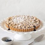 Blueberry crumble with wild blueberries, buttery short crust, and brown sugar oat topping, perfect with ice cream or whipped cream.
